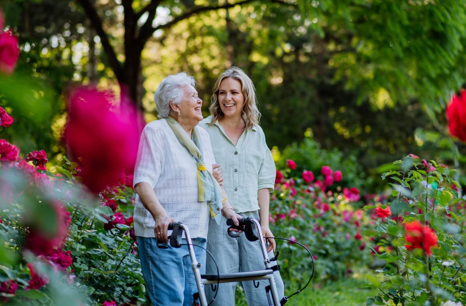 A senior and their adult child out for a walk in the community garden for some afternoon physical activity.
